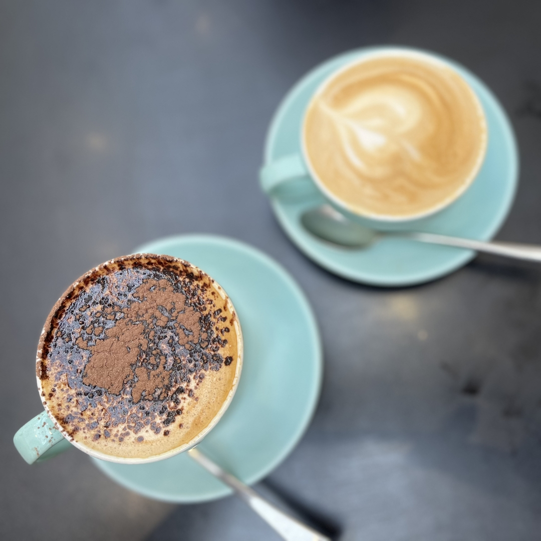 Two coffees, top view on a table